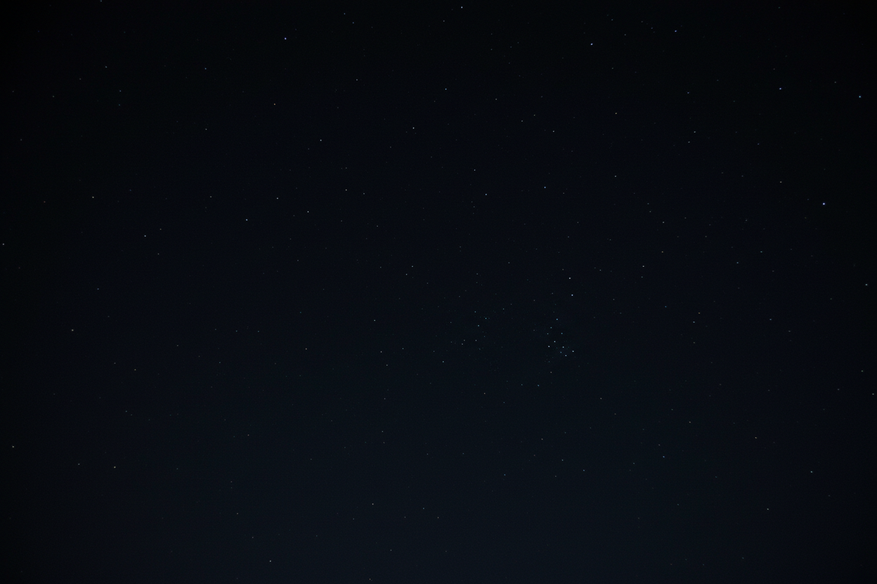 a starry sky but mostly black so that white writing will show up on top of it